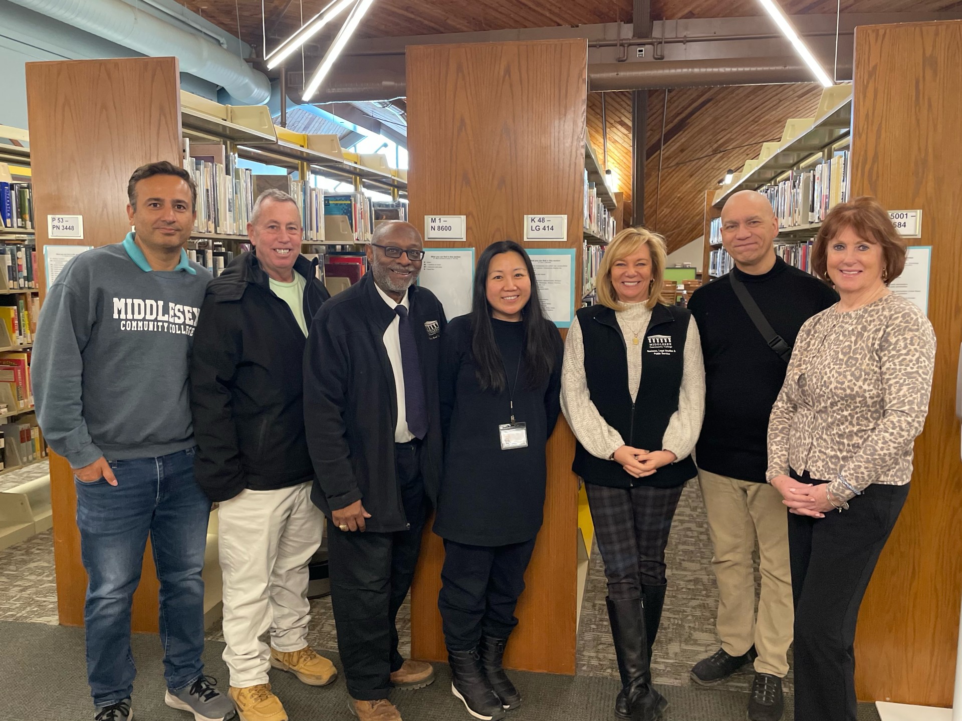 Professor Sharma Femia Dottin Ree Morrissey Grenier Hogan in library